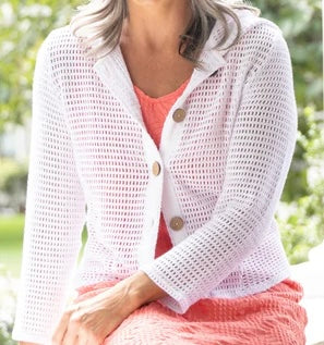 Habitat Sunburst Knit Cardigan in white, front view styled with black skirt, showing V-neck, pearl buttons, and open sunburst knit texture