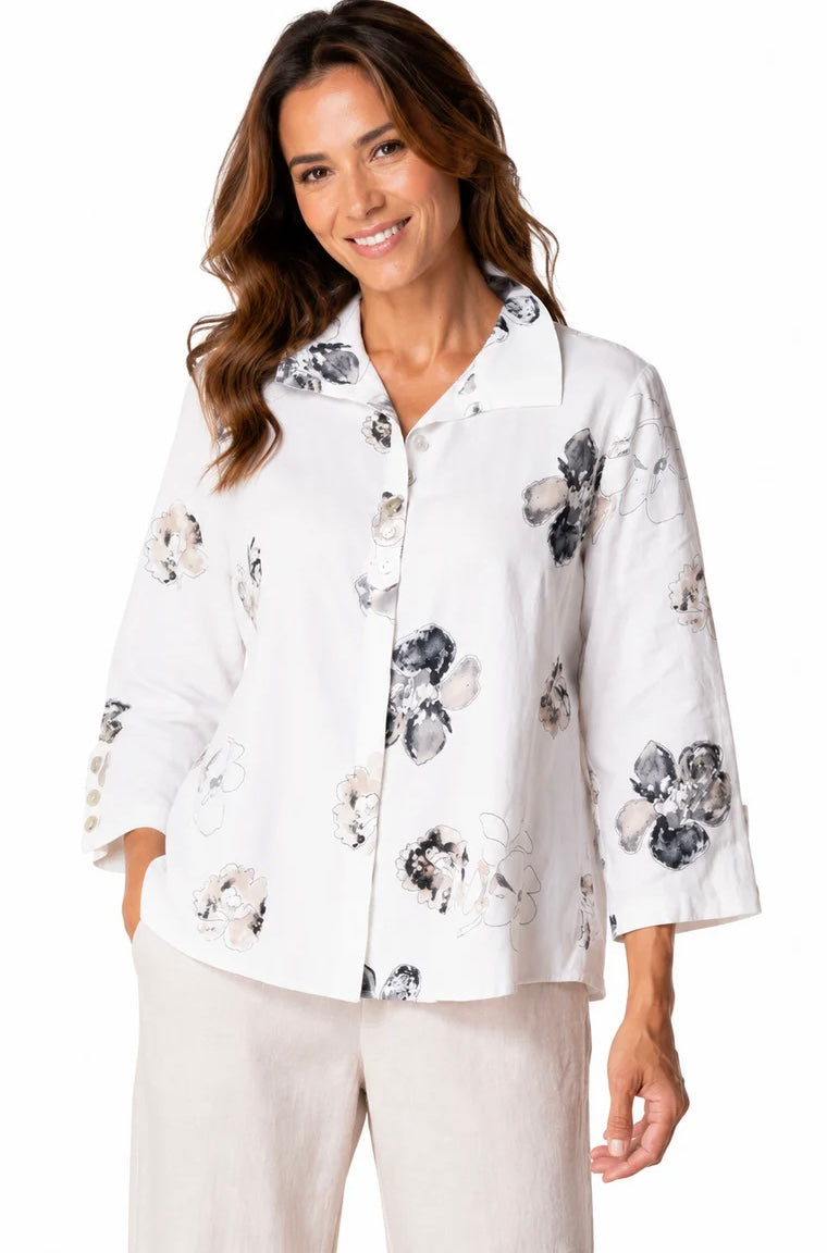 Front view (brunette model) — "Habitat Women's Watercolor Floral Swing Shirt in white with navy and taupe floral print, front view, smiling brunette model styled with linen trousers"
Back view (brunette model) — "Habitat Women's Watercolor Floral Swing Shirt in white with navy and taupe floral print, back view showing relaxed swing silhouette and 3/4 sleeves"
Close-up front — "Habitat Women's Watercolor Floral Swing Shirt in white with navy and taupe floral print, cropped front close-up showing button plack