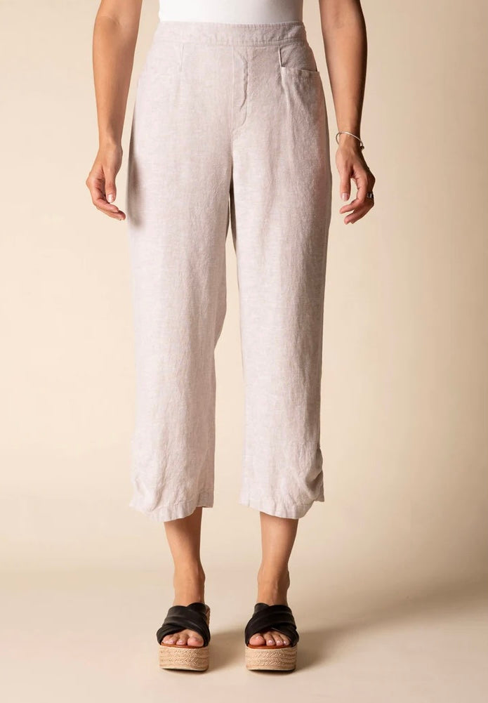 Front view (studio) — "Habitat Women's Linen Solid Pleat Button Capri in natural, front view showing pleat detail, side pockets, and cropped hem, styled with black platform wedge sandals"
Lifestyle shot — "Habitat Women's Linen Solid Pleat Button Capri in natural, full-length lifestyle shot on smiling curly-haired model styled with white floral shirt and black platform wedges, interior home setting"
Cropped front — "Habitat Women's Linen Solid Pleat Button Capri in natural, cropped front view highlighting p