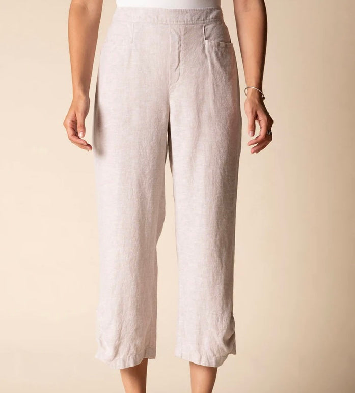 Front view (studio) — "Habitat Women's Linen Solid Pleat Button Capri in natural, front view showing pleat detail, side pockets, and cropped hem, styled with black platform wedge sandals"
Lifestyle shot — "Habitat Women's Linen Solid Pleat Button Capri in natural, full-length lifestyle shot on smiling curly-haired model styled with white floral shirt and black platform wedges, interior home setting"
Cropped front — "Habitat Women's Linen Solid Pleat Button Capri in natural, cropped front view highlighting p