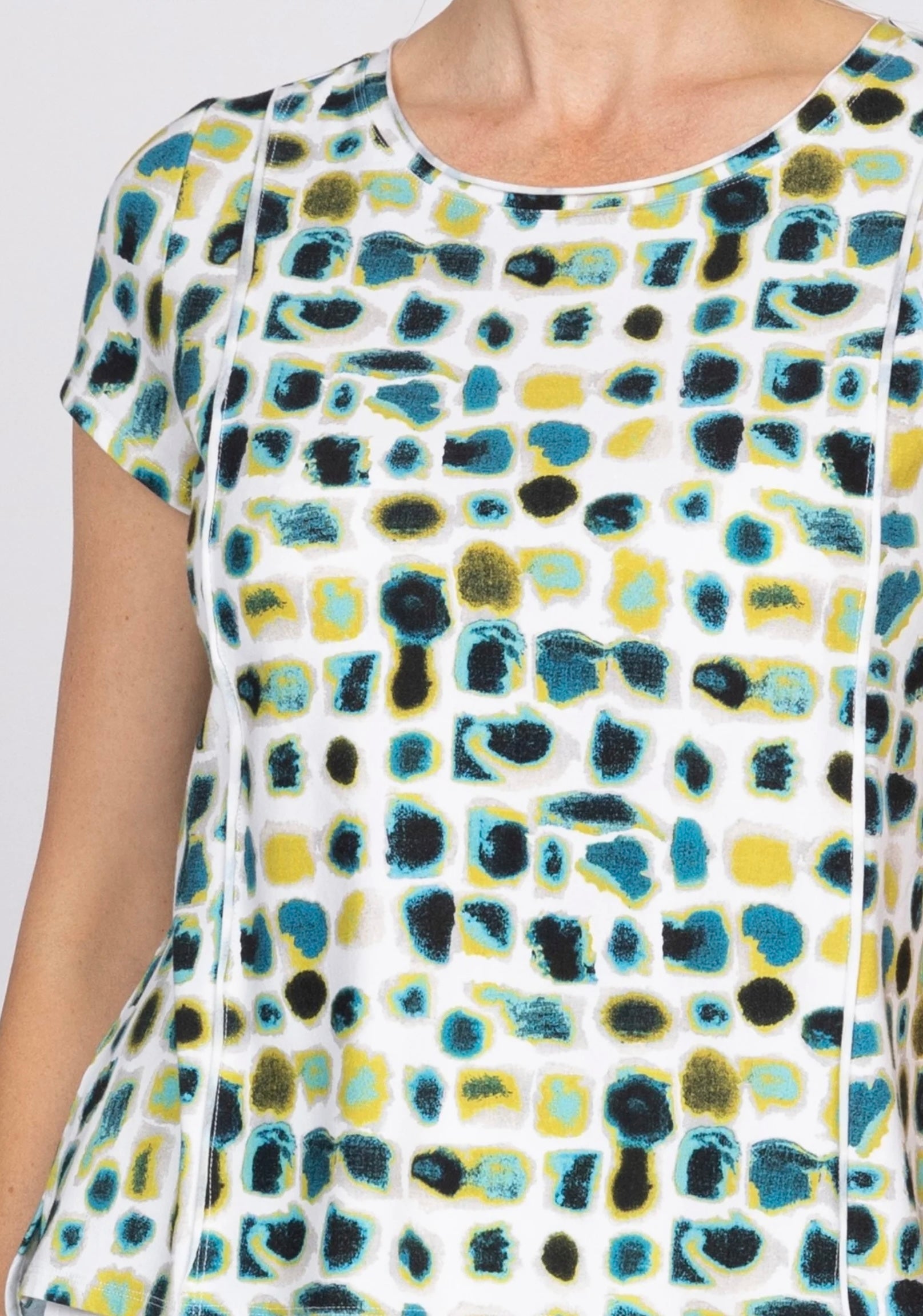Image 1 (front, full): "Women's dot print knit tee in teal, yellow, and black on white background, front view, round neckline, short sleeves"
Image 2 (back, full): "Women's dot print knit tee in teal, yellow, and black, back view showing relaxed silhouette and short sleeves"
Image 3 (front, torso crop): "Women's dot print knit tee, front torso close-up showing round neckline and abstract dot pattern in teal, yellow, and black"
Image 4 (neckline detail): "Close-up detail of women's knit tee neckline and abst