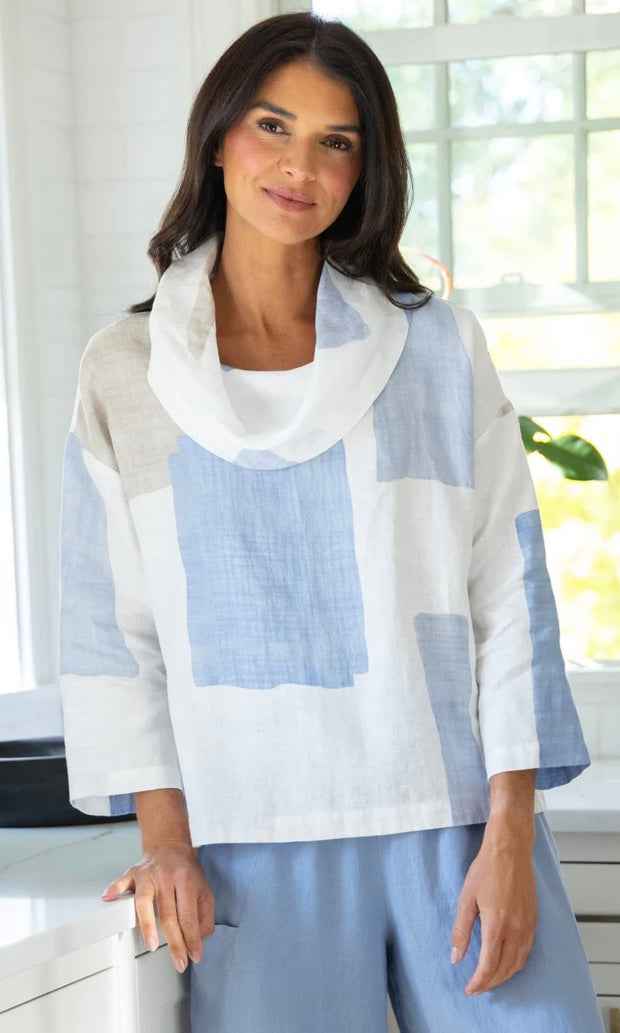 "Woman wearing Olivia by Habitat coastal colorblock linen cowl neck top in blue and white with relaxed fit, styled with blue wide-leg pants"