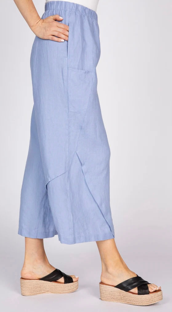 "Side view of Olivia by Habitat Crossroads Seamed Pant in lavender blue linen showing on-seam pocket and angled pleat hem detail"