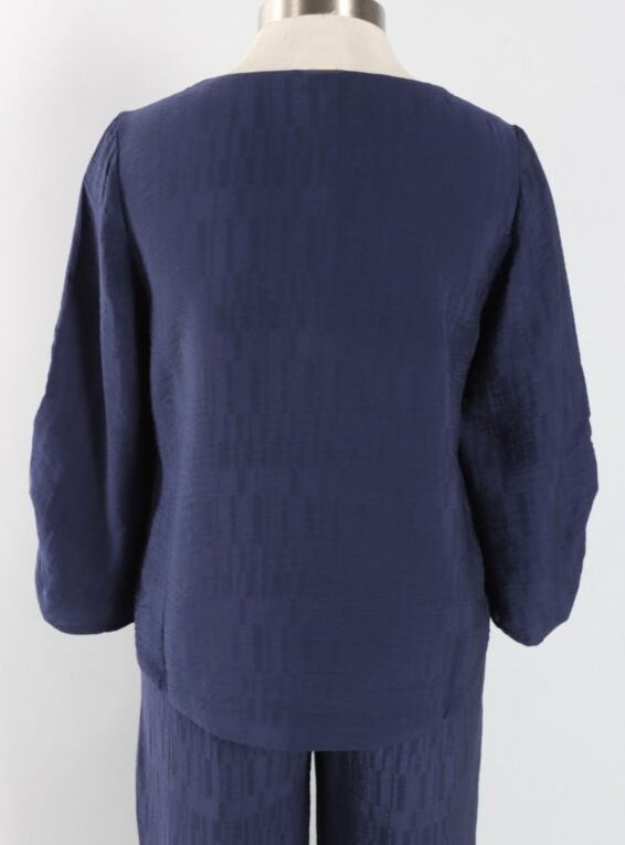A navy blue textured three-quarter sleeve top and matching pants set displayed on a mannequin from the back against a plain white background.