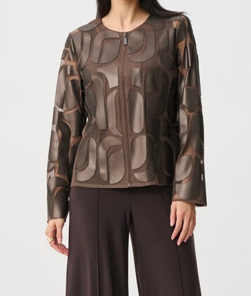 A woman wearing a brown and bronze metallic jacket with an abstract geometric pattern, paired with dark brown trousers, against a light gray background.