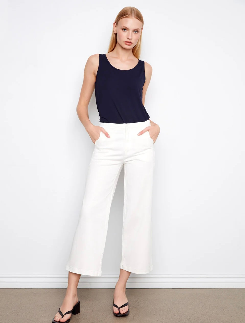 woman in white cropped jeans