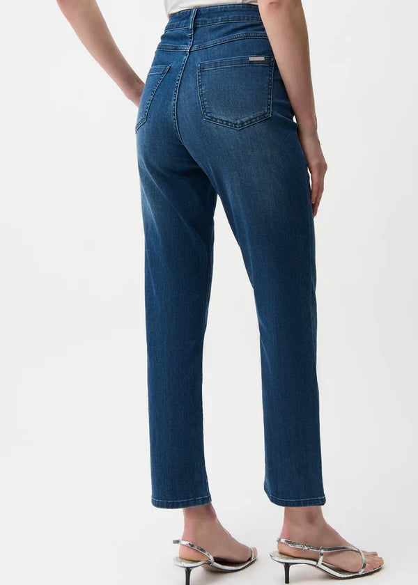 Blue jeans worn by a person on a white background
