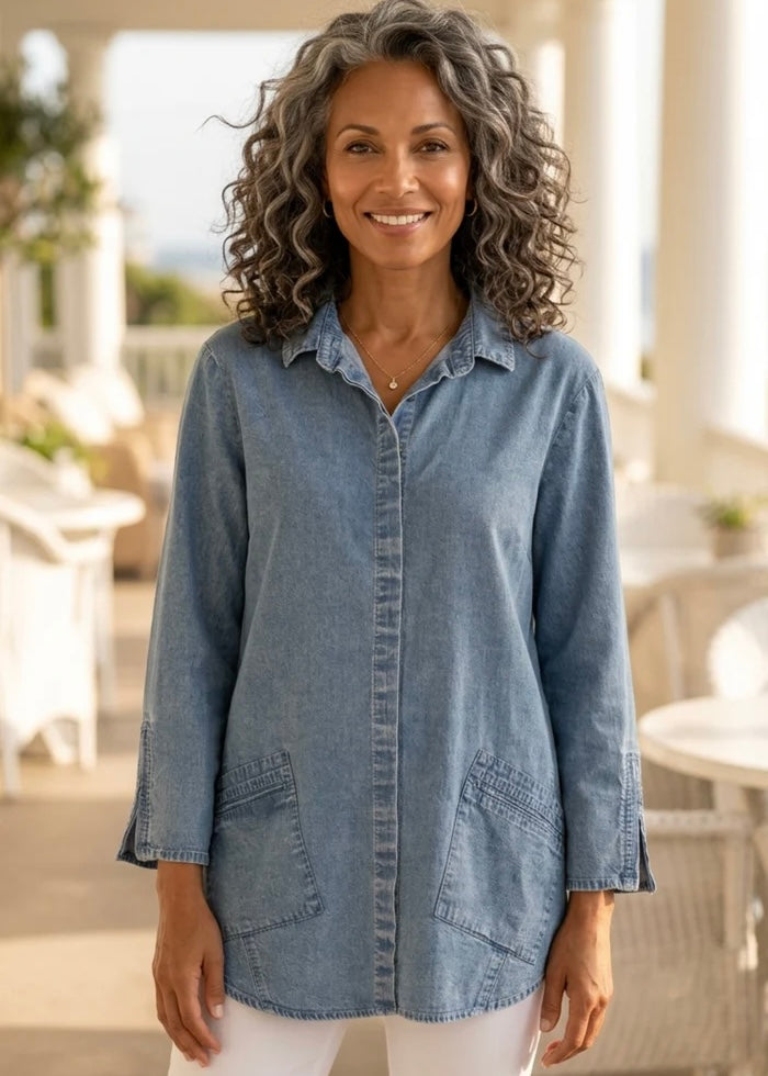 Woman wearing a denim shirt in an outdoor setting