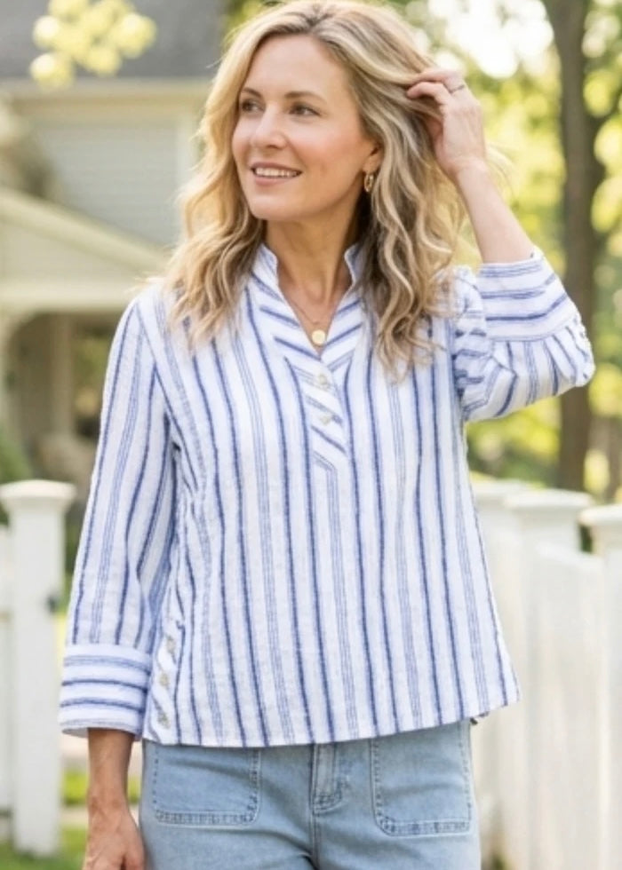 Woman wearing a blue and white striped shirt outdoors
