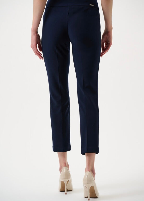 Navy blue pants worn by a person on a white background