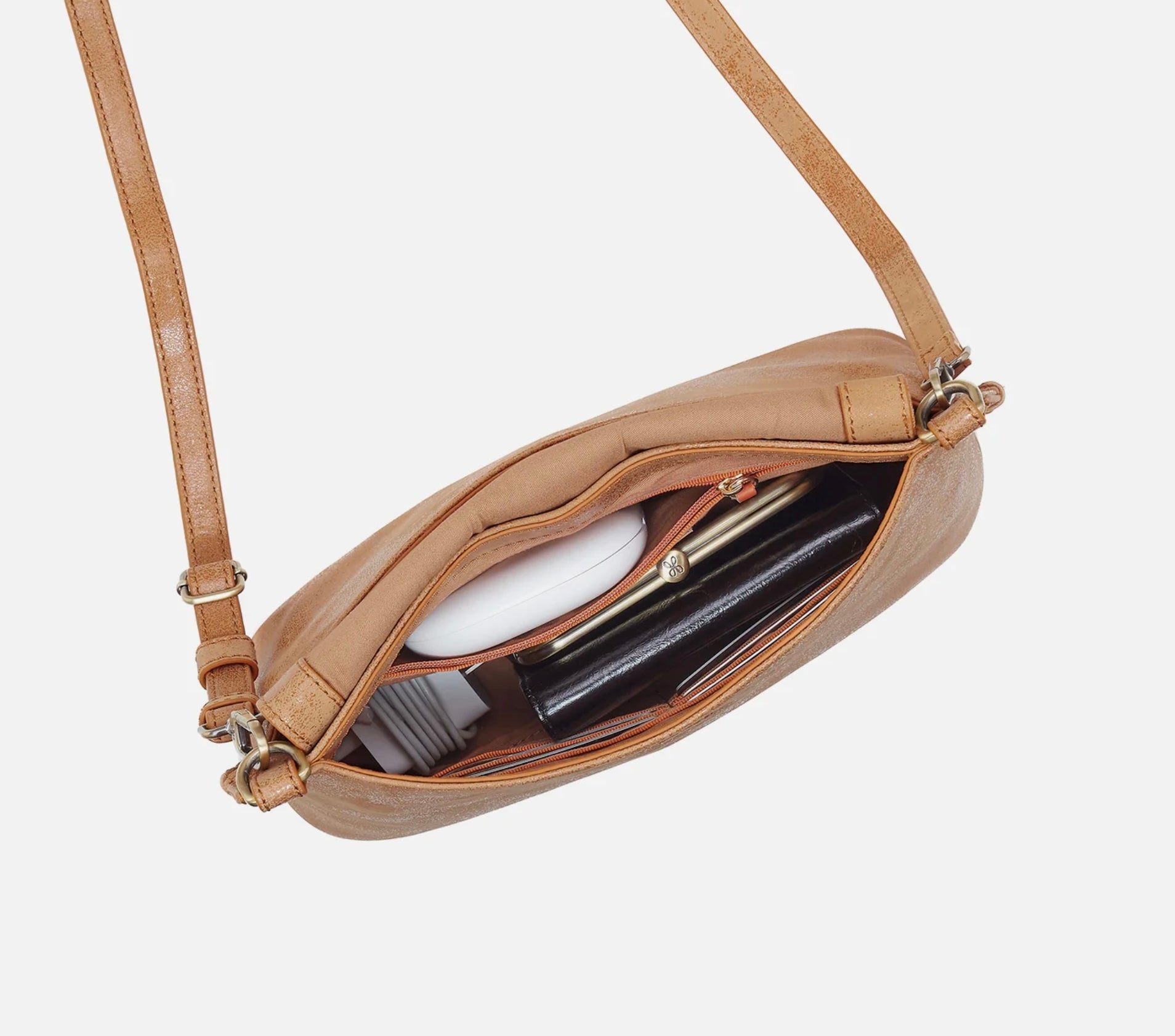 Beige crossbody bag with a white background