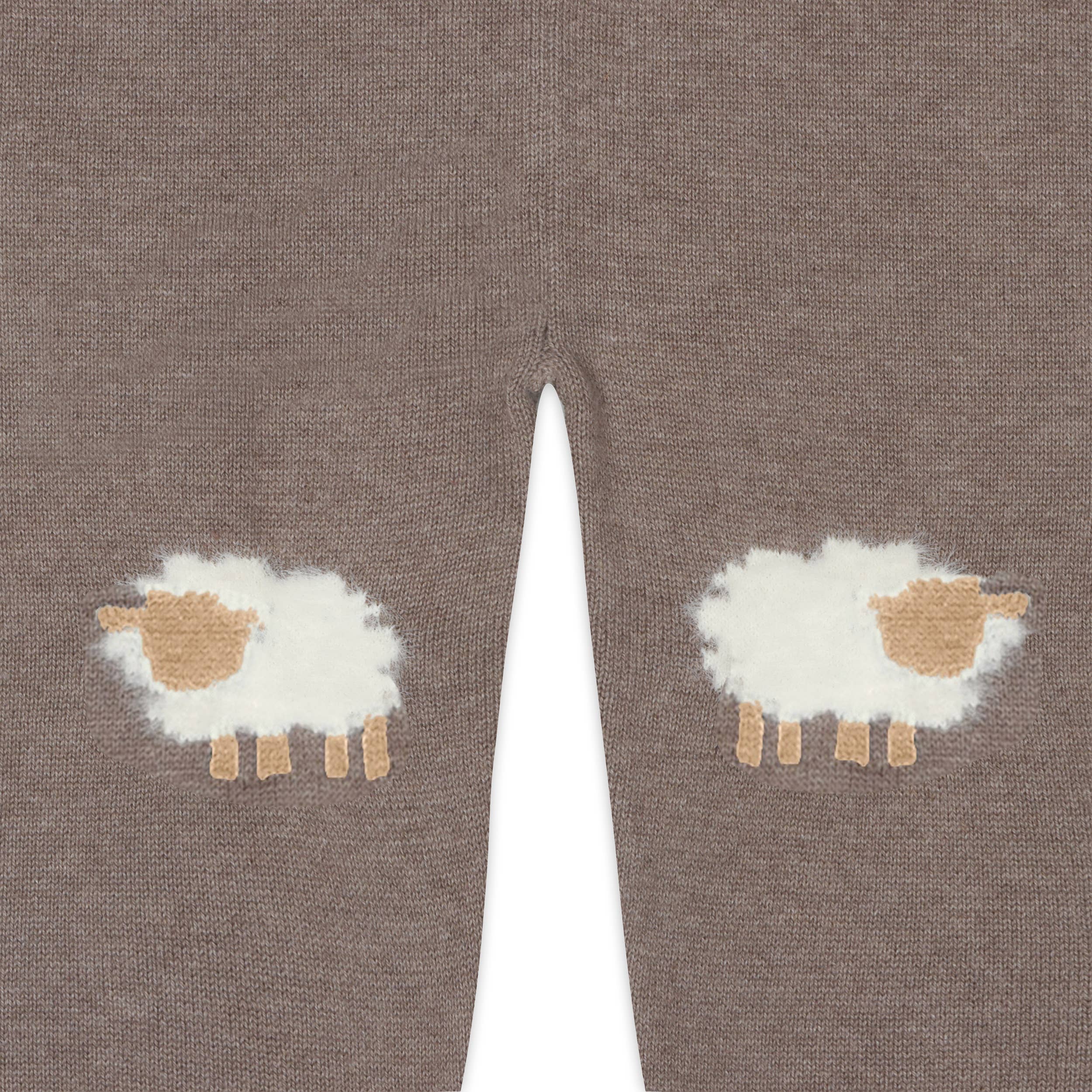 Brown knitted leggings with sheep designs on a white background