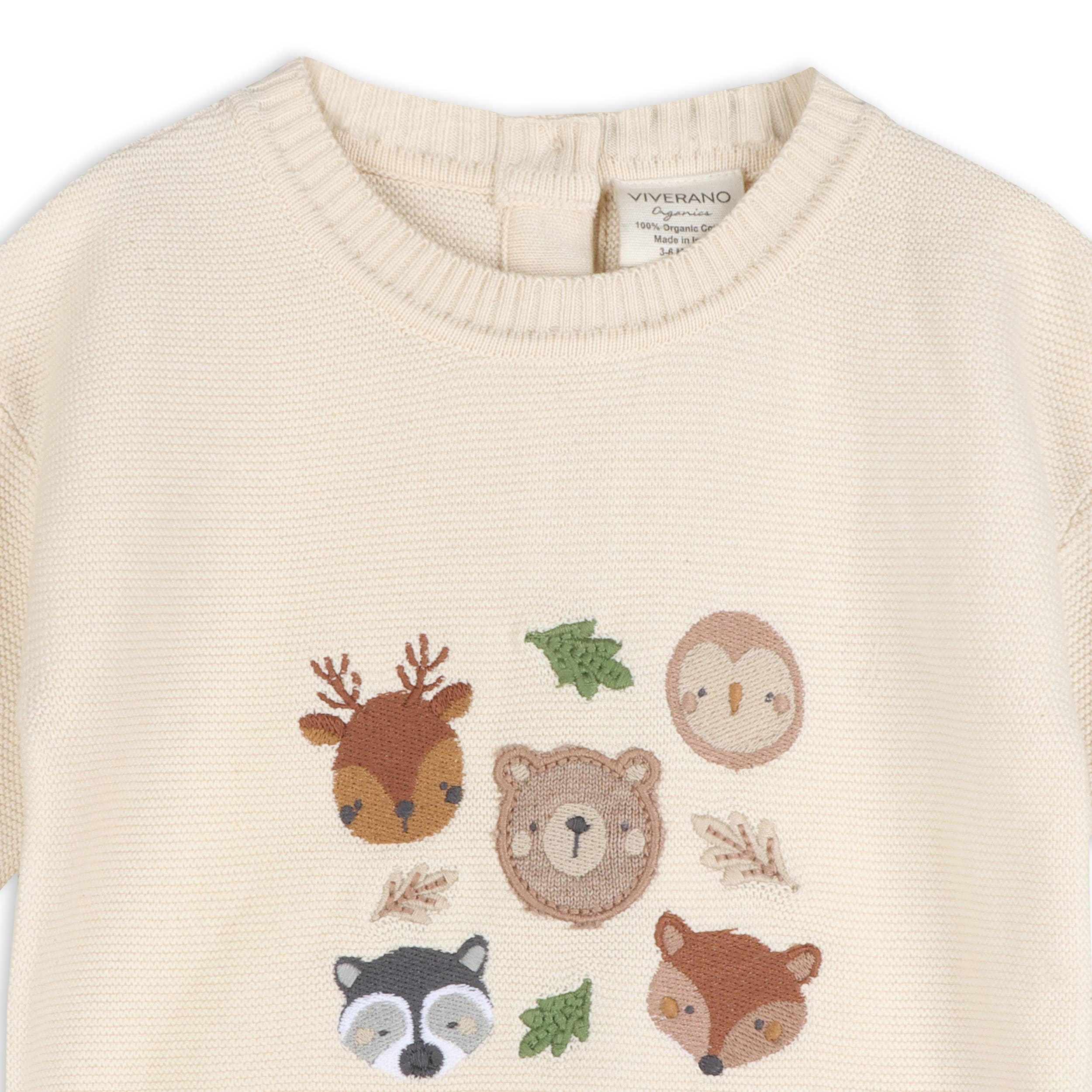 Beige sweater with embroidered animal designs on a white background