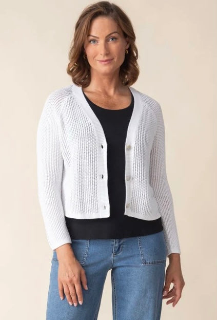 Habitat Sunburst Knit Cardigan in white, front view styled with black skirt, showing V-neck, pearl buttons, and open sunburst knit texture