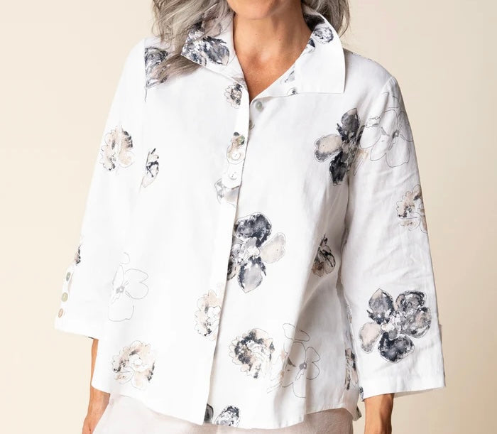 Front view (brunette model) — "Habitat Women's Watercolor Floral Swing Shirt in white with navy and taupe floral print, front view, smiling brunette model styled with linen trousers"
Back view (brunette model) — "Habitat Women's Watercolor Floral Swing Shirt in white with navy and taupe floral print, back view showing relaxed swing silhouette and 3/4 sleeves"
Close-up front — "Habitat Women's Watercolor Floral Swing Shirt in white with navy and taupe floral print, cropped front close-up showing button plack