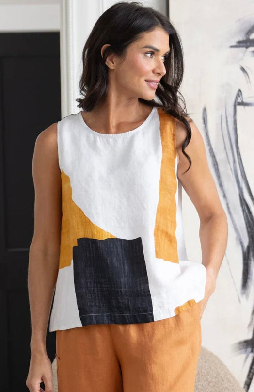 Olivia Women's Coastal Colorblock Sunset Tank in white linen with amber and navy abstract print, styled with rust linen pants