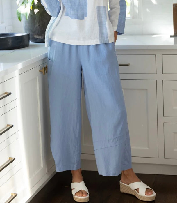"Olivia by Habitat Crossroads Seamed Pant in lavender blue linen worn with a colorblock linen jacket in a bright kitchen setting"
