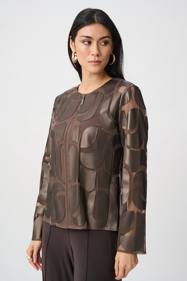 Woman wearing a brown patterned blouse against a white background