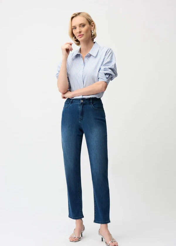 Woman wearing a striped shirt and blue jeans on a white background