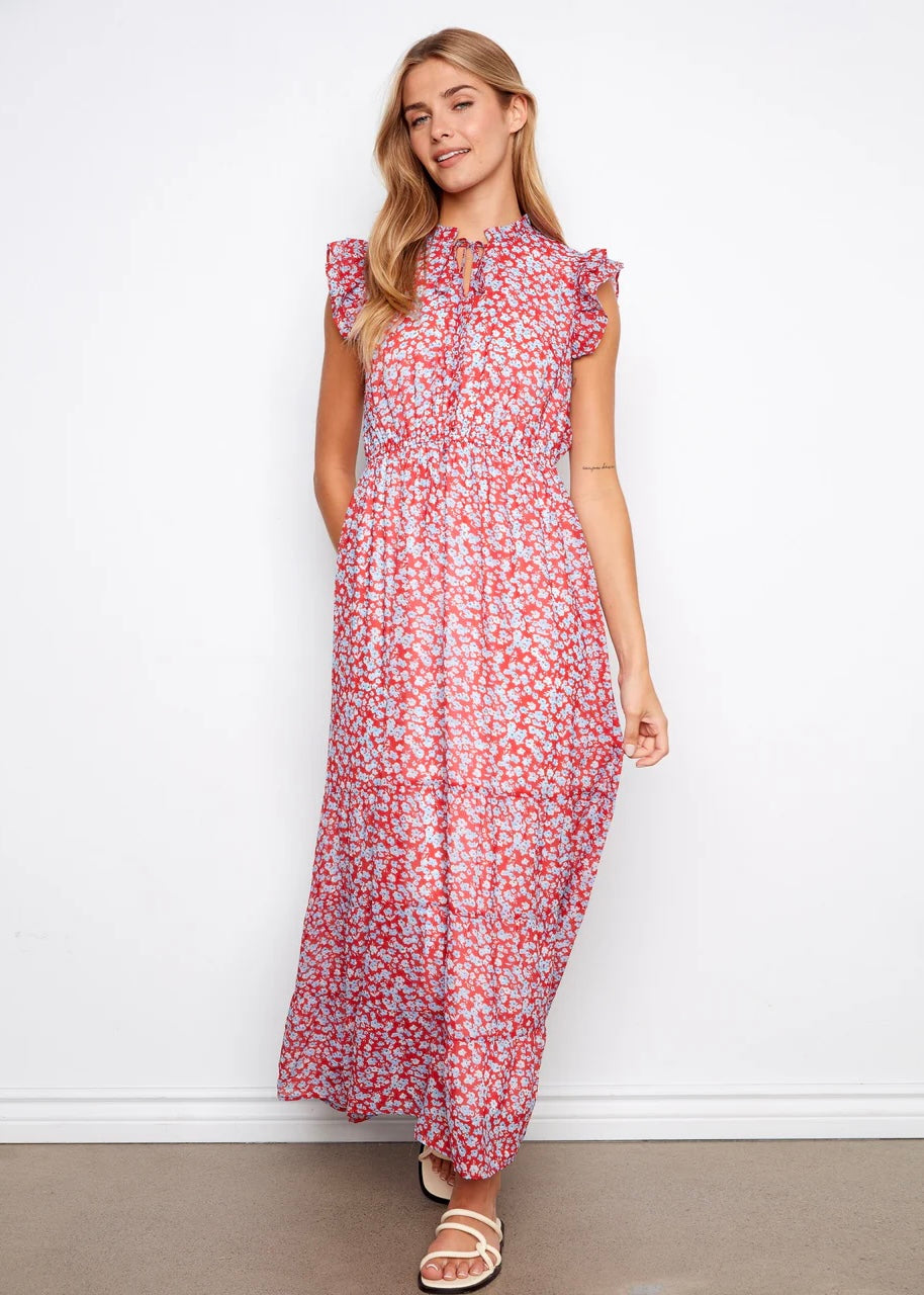 Woman wearing a red floral dress against a white background