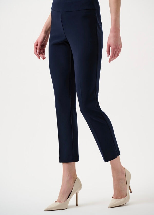 Navy blue pants worn by a person on a white background