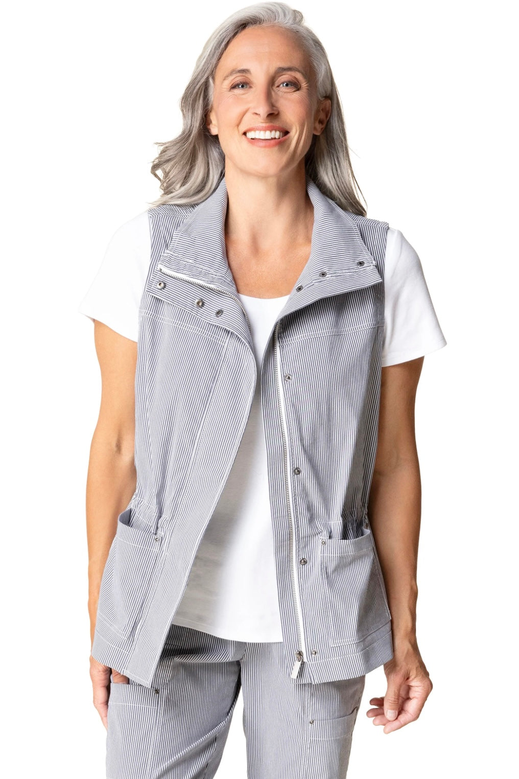 Woman wearing a light gray vest over a white shirt on a white background