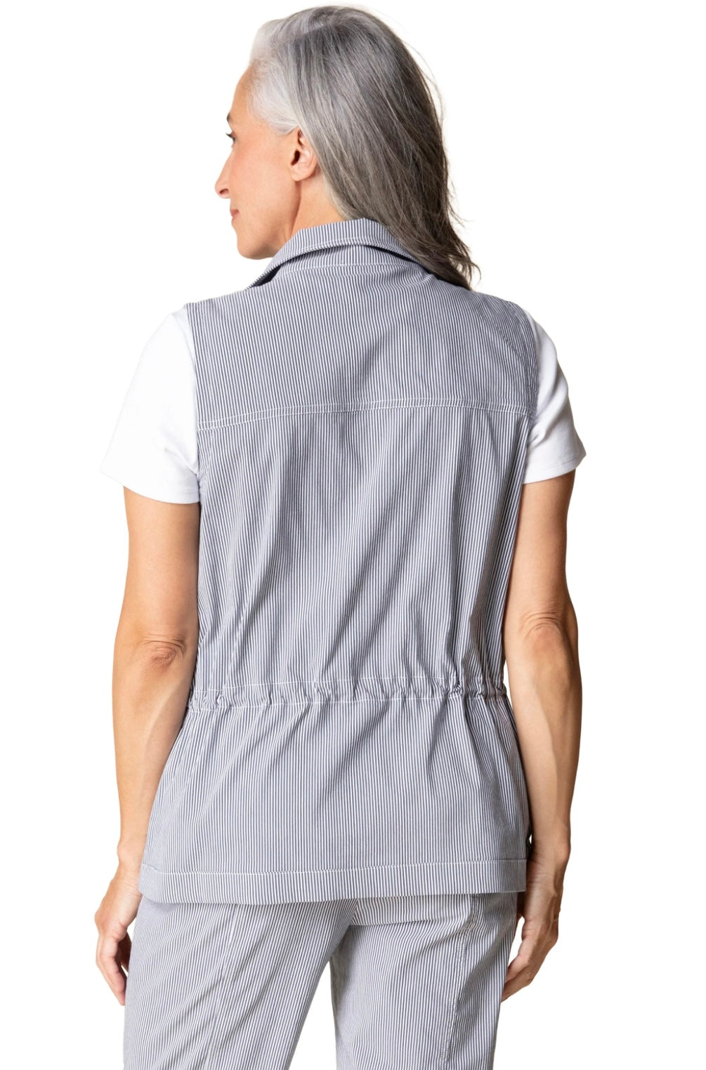 Person wearing a light gray checkered vest over a white shirt on a white background