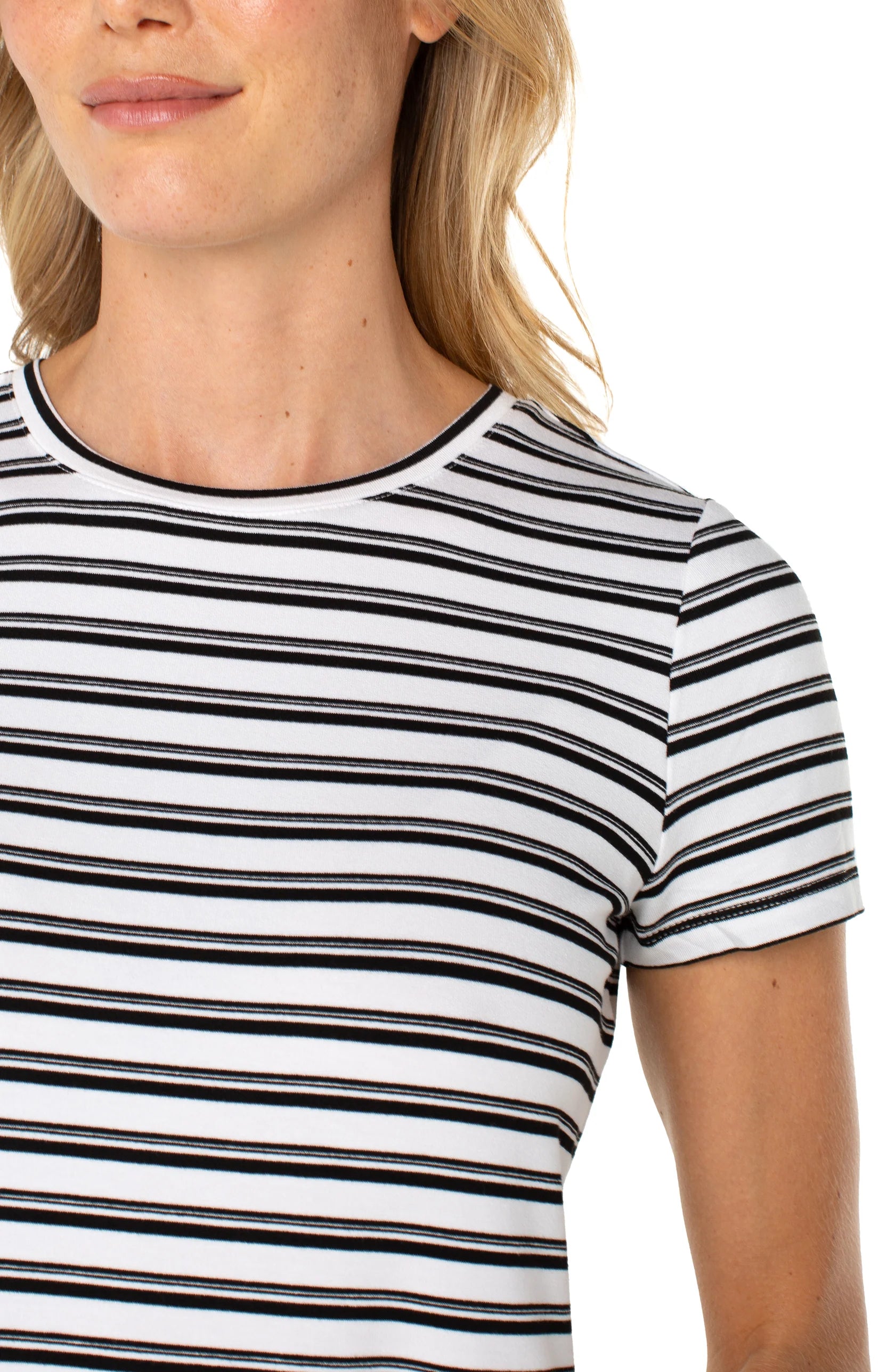 Close-up of a person wearing a black and white striped shirt on a white background
